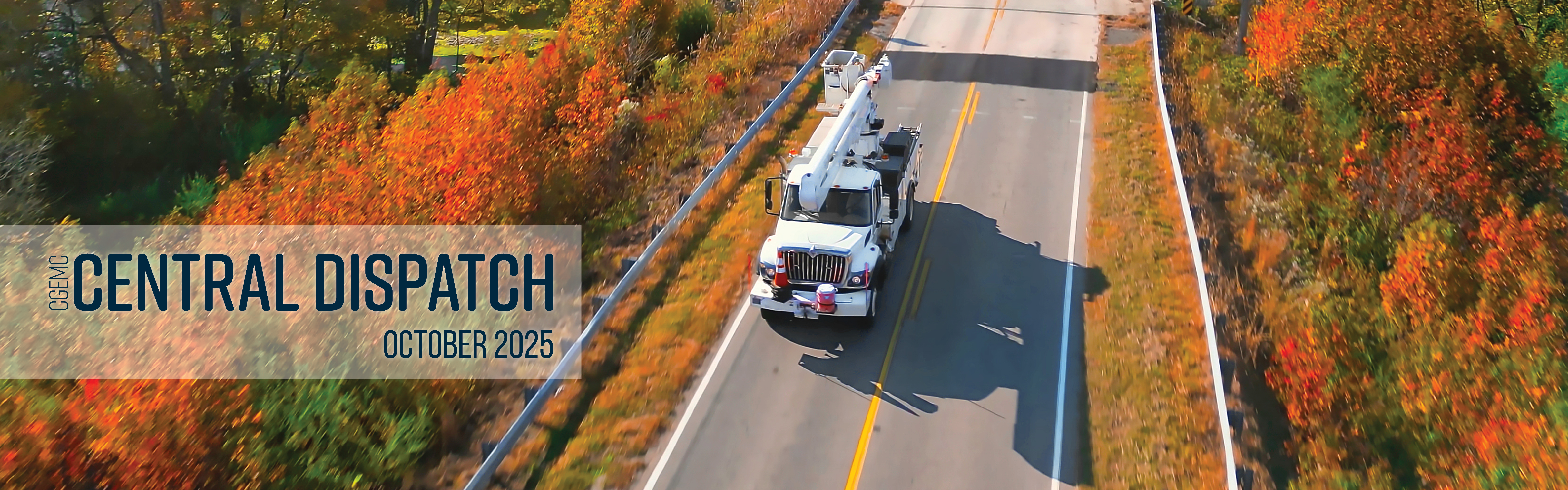Fall leaves and bucket truck on a two-lane road